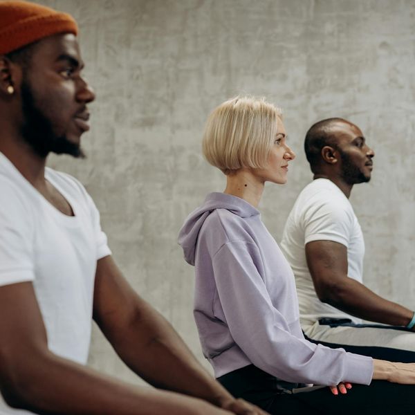 Group of diverse people sitting in a circle during a yoga class.